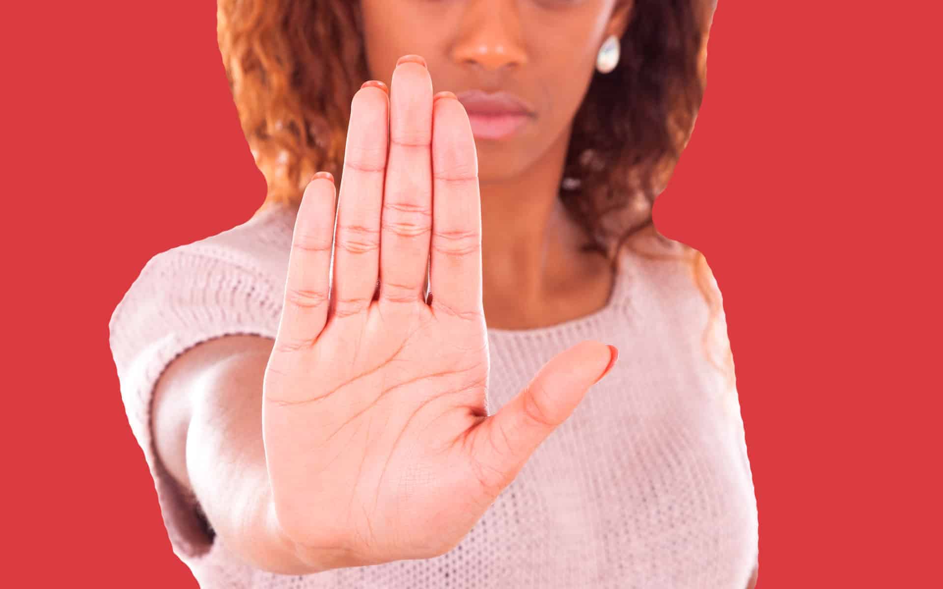 mujer latina afrodescendiente con gesto de alto en la mano